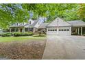 Traditional home with a two-car garage, American flag, and beautifully landscaped front yard at 1680 Huntington Dr, Marietta, GA 30066