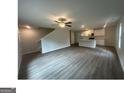 Open-concept living area with modern flooring seamlessly connects to the well-lit kitchen at 35 Emerald Ln # 14, Covington, GA 30014
