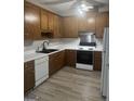 Traditional kitchen with white appliances, oak cabinets and light countertops at 871 Clearwater Rd, Sharpsburg, GA 30277
