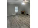 Bright living room with light gray walls, ceiling fan and decorative fireplace at 871 Clearwater Rd, Sharpsburg, GA 30277