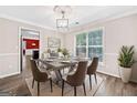 Dining room featuring modern lighting, large window, hardwood floors, and table with seating at 2967 Albright Commons, Kennesaw, GA 30144
