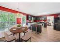 Eat-in kitchen with dark cabinetry, stainless steel appliances, breakfast table, and bright red walls at 2967 Albright Commons, Kennesaw, GA 30144