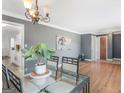 Dining room with hardwood floors, elegant chandelier, and views to kitchen at 5875 Highway 92, Fairburn, GA 30213