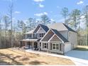 New construction home featuring a side-entry garage, large lawn, and wooded lot at 980 Temple Draketown Rd, Temple, GA 30179