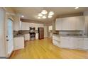 Spacious kitchen with white cabinets, stainless steel appliances, and hardwood floors at 2001 Fairbrook Ln, Woodstock, GA 30189