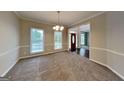 Bright living room with large windows and neutral carpet at 2001 Fairbrook Ln, Woodstock, GA 30189