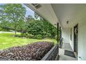 Inviting covered front porch with manicured landscaping at 40 Salem Ct, Mcdonough, GA 30252