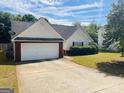 View of a home with an attached garage, manicured lawn, and inviting curb appeal at 6190 Winston Trce, Mcdonough, GA 30252