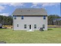 Back exterior view features a large yard, exterior access door and multiple windows at 635 Cantrell Drive, Dallas, GA 30157