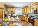Functional kitchen features wood cabinets, modern appliances, granite countertops, and lots of natural light at 871 Rocky Creek Rd, Hampton, GA 30228
