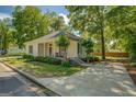 Well-kept home featuring neutral siding, covered front porch, established landscaping and long driveway leading to backyard gate at 3170 Butler Se Ave, Covington, GA 30014