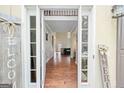 A view into this home with hardwood floors and a view into the home's living spaces and the staircase at 1130 S Rudder Rd, Cumming, GA 30041