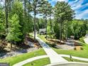 Picturesque aerial of home situated among mature trees and featuring a long driveway at 120 Laurel Forest Dr, Tyrone, GA 30290