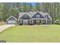Attractive exterior view of home with detached garage and long private driveway at 120 Laurel Forest Dr, Tyrone, GA 30290