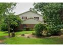 Charming two-story home with a mix of siding and brick, complemented by lush landscaping at 7369 Aubrey Dr, Riverdale, GA 30296