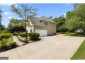 Spacious garage and driveway offering ample parking, set amidst a landscaped yard at 115 Roscommon Ct, Tyrone, GA 30290