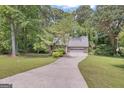Traditional brick home boasts a two-car garage and well-maintained lawn at 886 Pine Needle Rd, Hampton, GA 30228