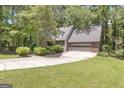 A beautiful property showcases a spacious driveway leading to a two-car garage at 886 Pine Needle Rd, Hampton, GA 30228