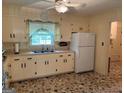 Traditional kitchen with ample counter space, white appliances, and cozy window with lots of light at 18 North Ave, Hampton, GA 30228