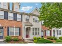 Attractive townhome showcases a classic brick facade, inviting entrance, and well-maintained landscaping at 1363 Penhurst Dr, Lawrenceville, GA 30043