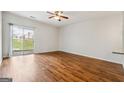 Bright and airy living room featuring hardwood floors and sliding glass doors to the outdoor space at 1363 Penhurst Dr, Lawrenceville, GA 30043