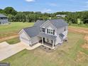 Aerial view of a well-maintained home with a spacious yard in a serene, wooded setting at 715 Colvin Dr, Locust Grove, GA 30248