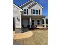 Charming covered front porch with white columns and black shutters on a two-story home at 715 Colvin Dr, Locust Grove, GA 30248