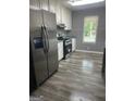 Well-lit kitchen featuring stainless steel appliances, granite countertops and modern white cabinetry at 324 Cynthia Ct, Jonesboro, GA 30238