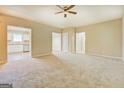 Spacious living room featuring neutral carpet and open access to the kitchen at 126 Usher Ln, Covington, GA 30016