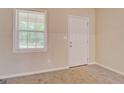 Bright room with plush carpeting, a window with blinds, and a white door at 126 Usher Ln, Covington, GA 30016