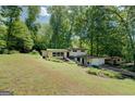 Two-story home with expansive lawn, mature trees, and side-entry garage, offering a serene living environment at 3449 Archwood Dr, Doraville, GA 30340