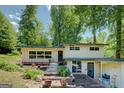Inviting front entrance with a charming walkway and lush garden beds. A tranquil chair sits near the entry at 3449 Archwood Dr, Doraville, GA 30340