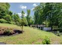Lush front yard with a mature tree and garden, complementing the appealing exterior of this lovely home at 3449 Archwood Dr, Doraville, GA 30340