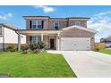 Beautiful two-story home with a well-kept lawn, stone accents, a welcoming front porch, and an attached two-car garage at 3460 Sycamore Sw Dr, South Fulton, GA 30331