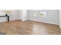 Bright room with wood-look floors and a large window, offering a versatile space for various uses and ample natural light at 3460 Sycamore Sw Dr, South Fulton, GA 30331