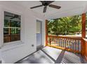 View of cozy porch with rustic wood railings and ceiling fan; a tranquil outdoor space at 985 Columbia Dr, Decatur, GA 30030