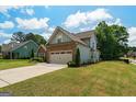 Beautiful home with stone accents, blue siding, a well-kept lawn, and a convenient attached two-car garage at 207 Brookstone Dr, Carrollton, GA 30116