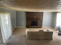 Cozy living room with a brick fireplace, carpeted floor, and lots of natural light at 1028 Dixie Dr, Jonesboro, GA 30236