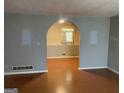 Inviting living room featuring a stylish arched entryway, wood flooring, and neutral wall colors at 1028 Dixie Dr, Jonesboro, GA 30236