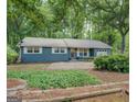 Lovely single-story home with mature landscaping, gravel driveway, and inviting front entrance at 357 Oak Hill Rd, Covington, GA 30016