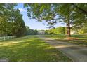 Long driveway leading to this beautiful home nestled amongst mature trees and lush greenery at 885 Kelleytown Rd, Mcdonough, GA 30252