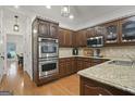 This kitchen has dark cabinets, stainless steel appliances and granite countertops at 885 Kelleytown Rd, Mcdonough, GA 30252