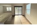 Bright living room with wood flooring, sliding glass doors, and natural light at 2051 Blue Sky Ave, Covington, GA 30016