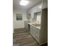 Modern kitchen features stylish cabinetry, granite countertops, and updated stainless sink at 103 Tiburon Ct, Stonecrest, GA 30038