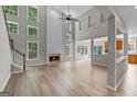 Spacious living room with hardwood floors, a fireplace, and large windows at 1429 Kentmire Court, Locust Grove, GA 30248