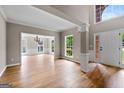 Bright living room featuring hardwood floors, large windows, and an open floor plan at 1429 Kentmire Court, Locust Grove, GA 30248