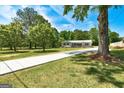 Beautifully landscaped front yard with a long driveway leading up to the charming home at 203 Brannan Rd, Mcdonough, GA 30253