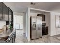 Open kitchen layout with stainless steel refrigerator and access to the laundry room at 203 Brannan Rd, Mcdonough, GA 30253