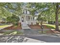 Inviting two-story home with a classic porch, lovely landscaping, and a lush green lawn at 100 Concord Ct, Fayetteville, GA 30214