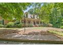 Beautiful brick home with a large front yard and mature trees, offering privacy at 9274 Betony Wood Trl, Jonesboro, GA 30236